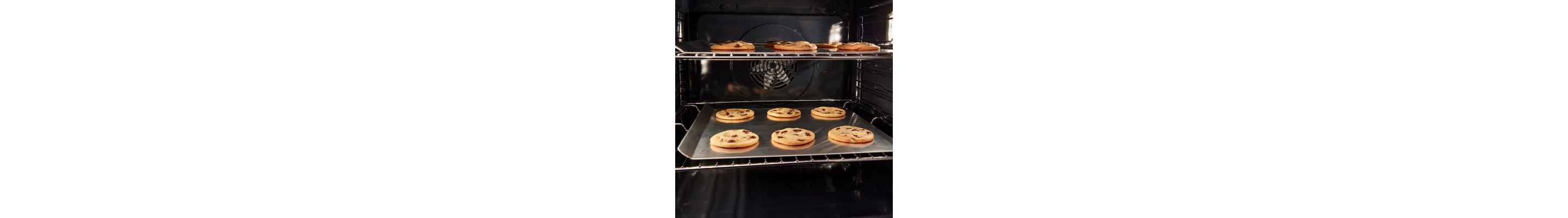 Cookies on baking sheets inside oven
