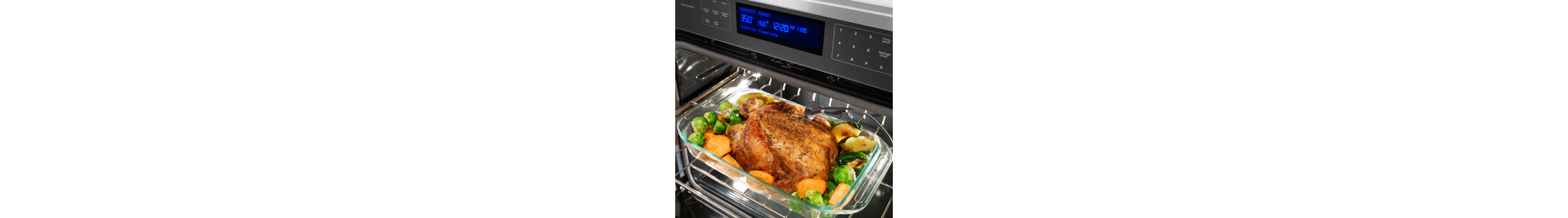 Turkey roasting in pan with veggies inside oven