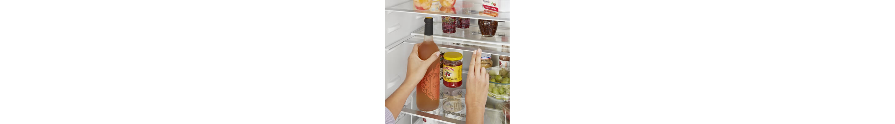 Person placing wine inside a refrigerator