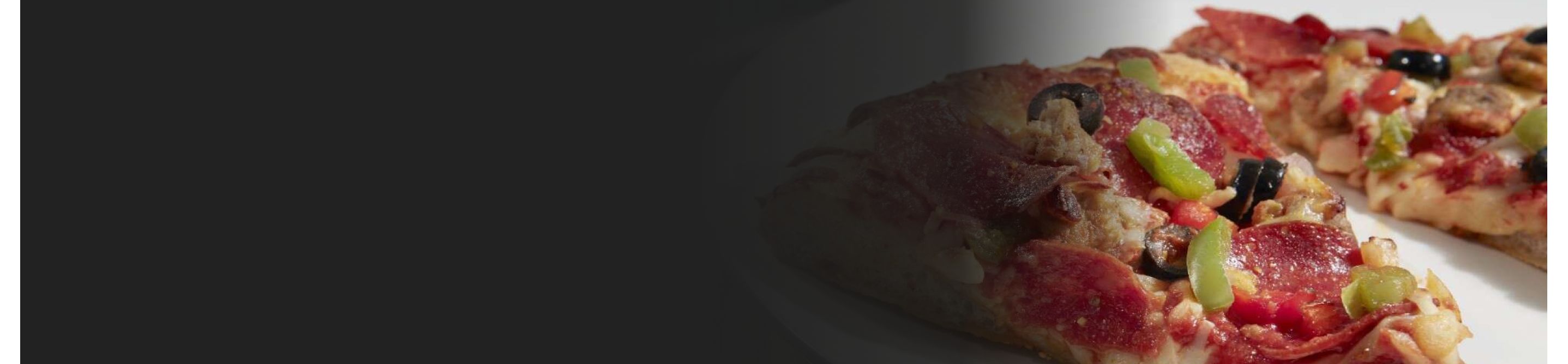Close-up of a slice of pizza with assorted toppings