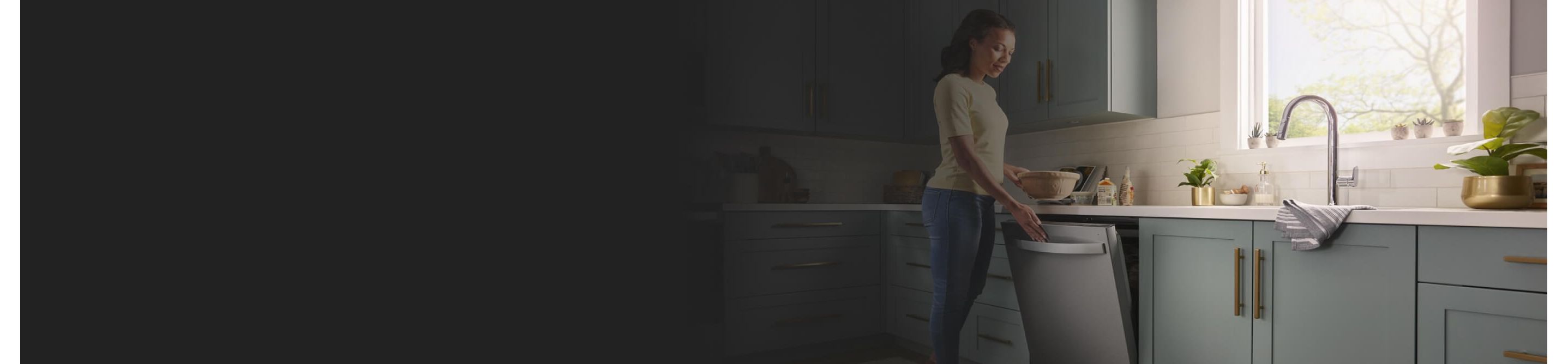 A person opening a Whirlpool® Dishwasher in a modern kitchen