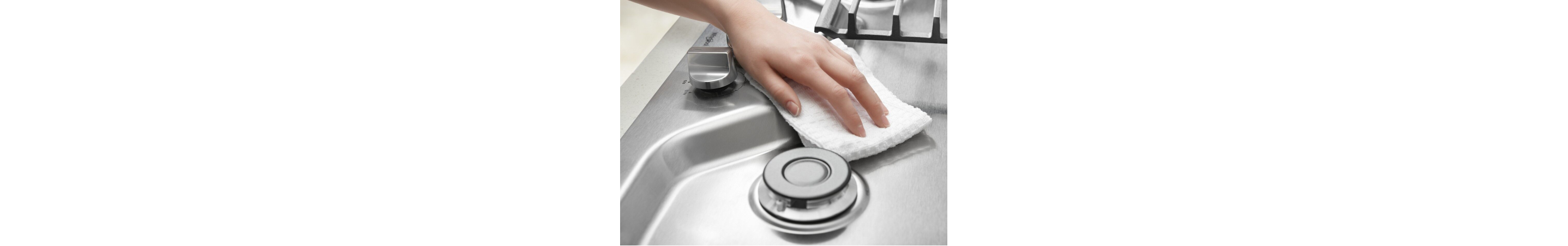 Hand wiping down stovetop
