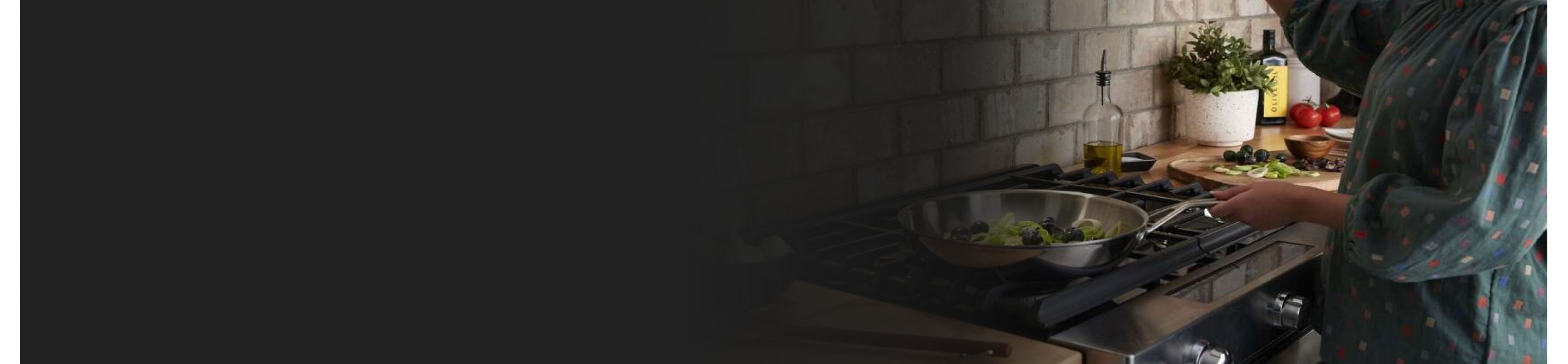 Person cooking broccoli in a pan