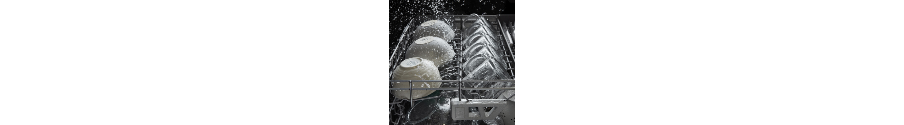 Bowls and mugs inside a dishwasher during a cycle