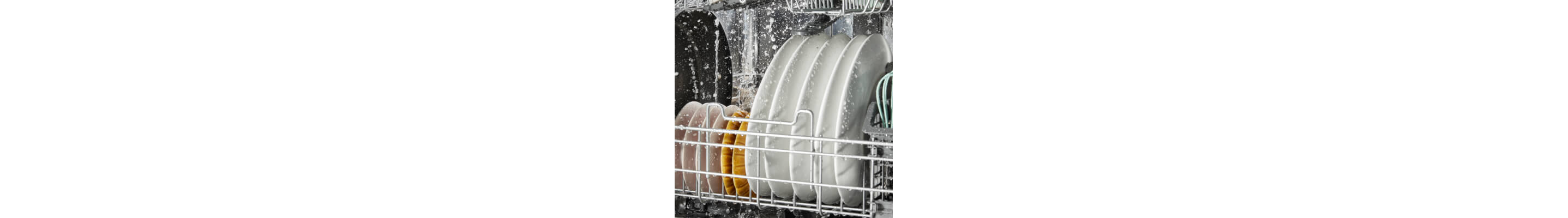 Stacked plates being cleaned inside a dishwasher