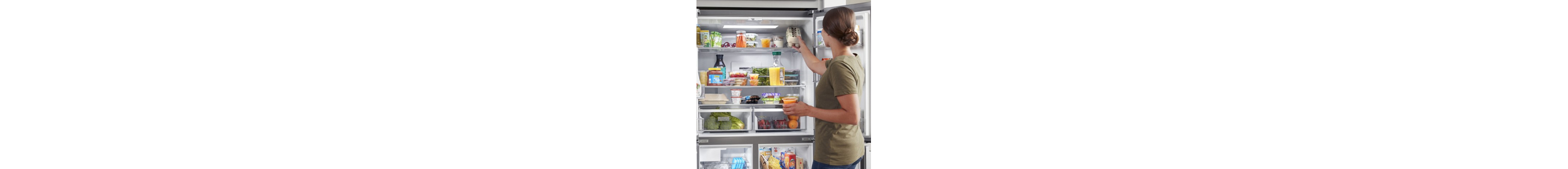 Person putting food inside a refrigerator