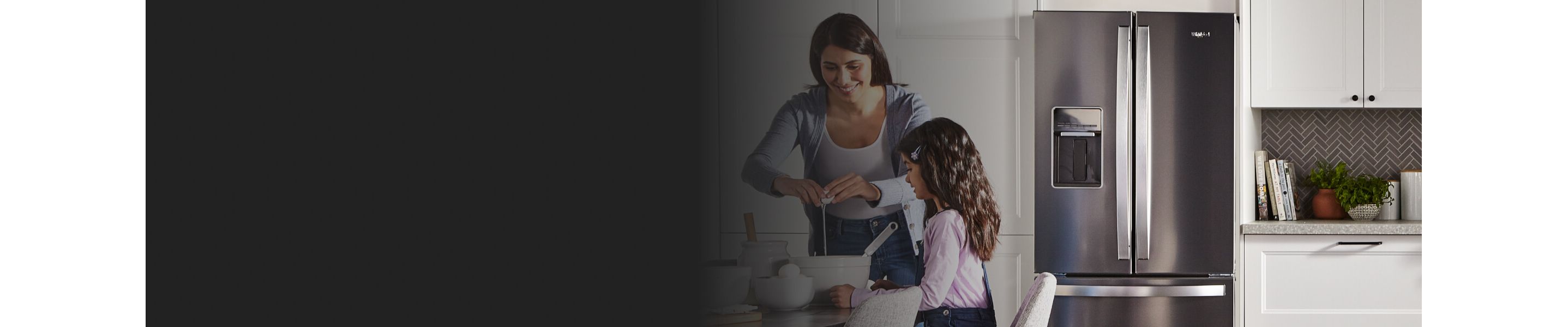 Woman and child cooking in front of a French door refrigerator
