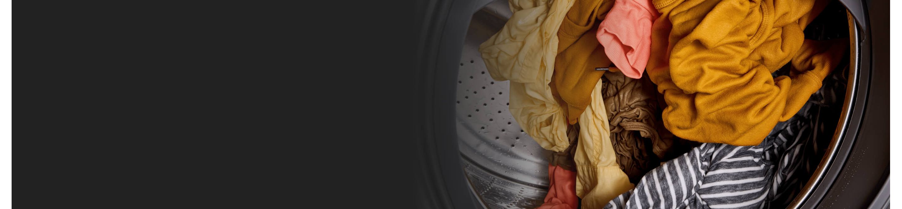 Colored clothes tumbling inside of washer