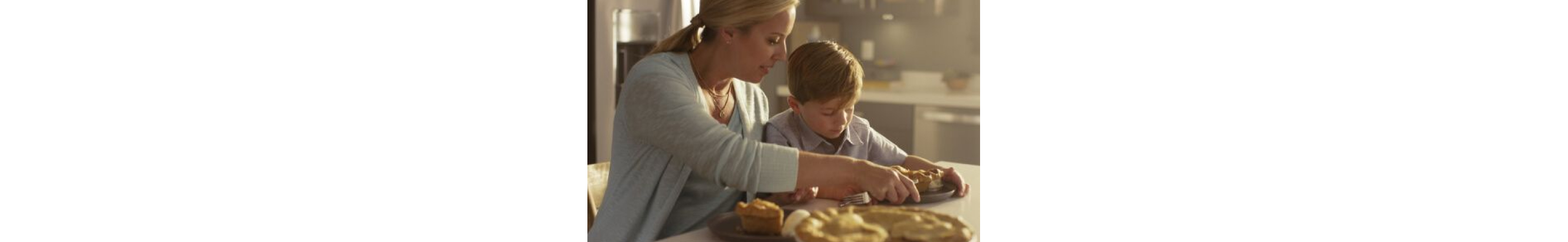 A mom serving her son a slice of pie