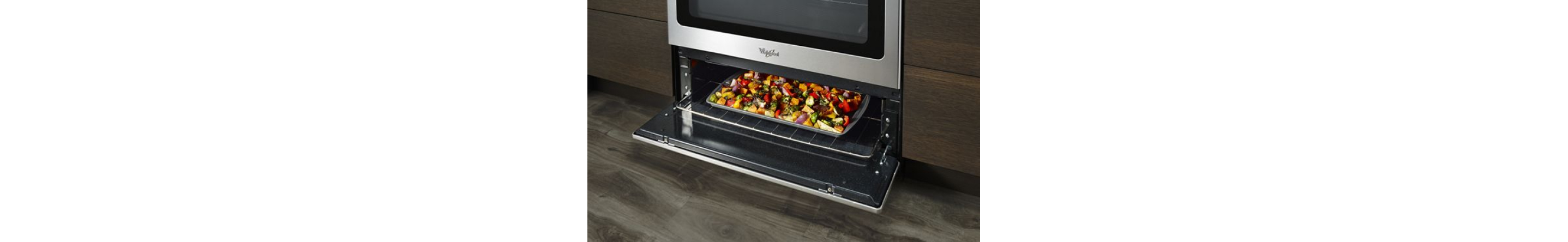 A sheet pan of vegetables in an under-oven broiler