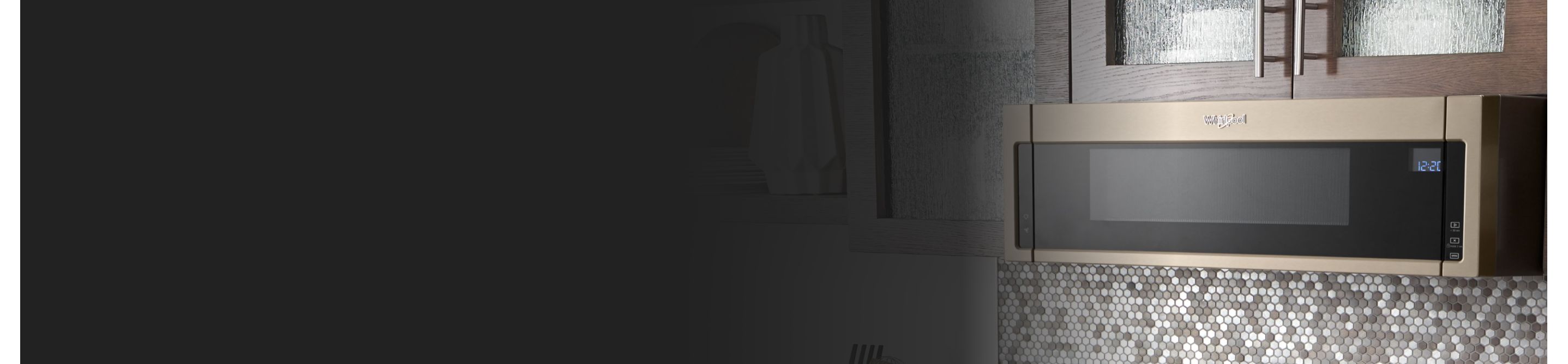 Bronze Whirlpool® low profile microwave below brown cabinetry