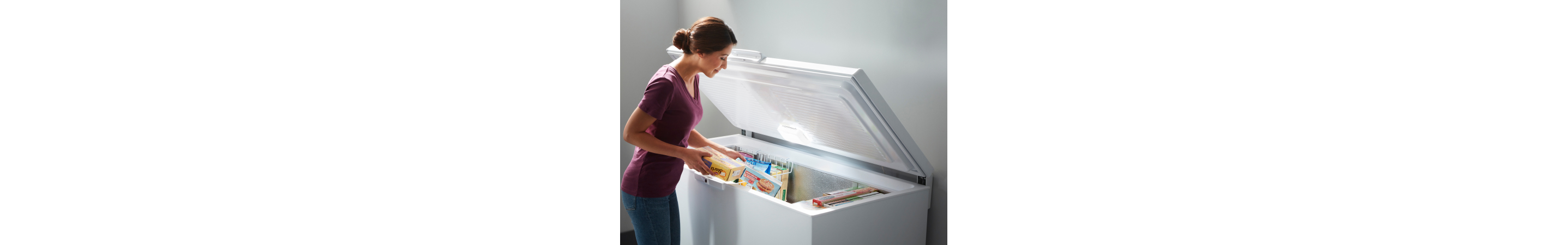 Woman taking items from a deep freezer