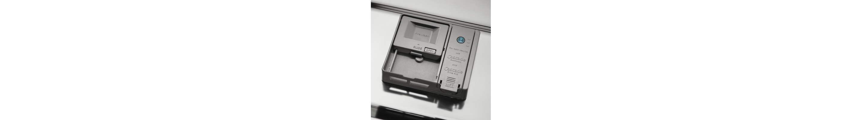 A detergent dispenser of a Whirlpool® dishwasher.