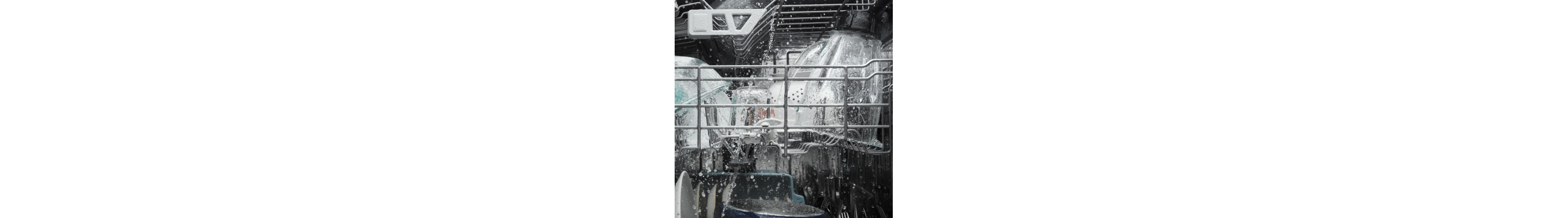 A closeup of the upper rack of a Whirlpool® dishwasher washing dishware during a wash cycle.