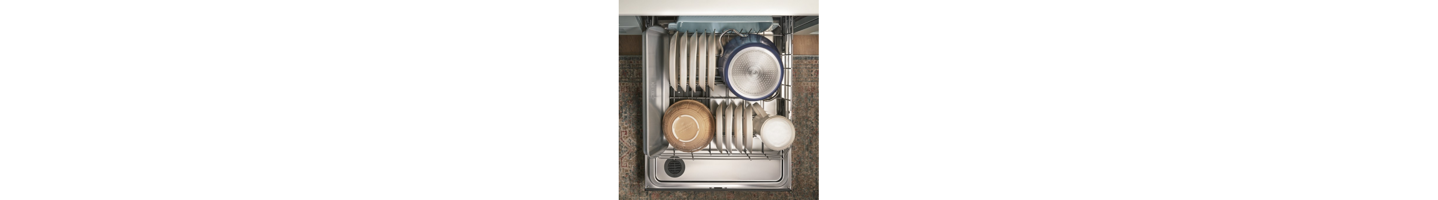 An overhead view of the bottom rack of a Whirlpool® dishwasher with dishware.