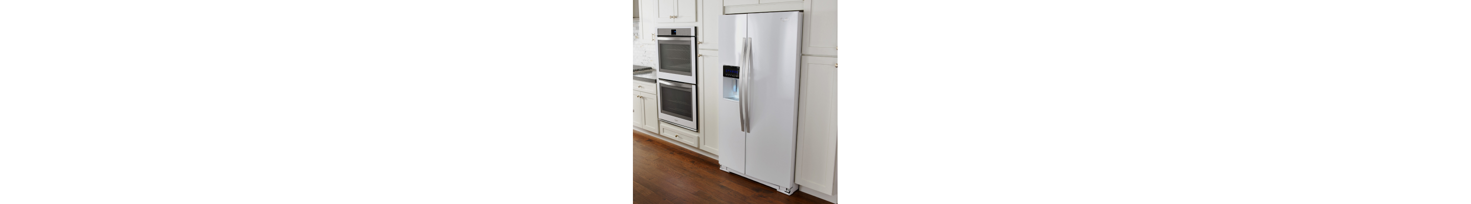 White side-by-side refrigerator in white cabinetry