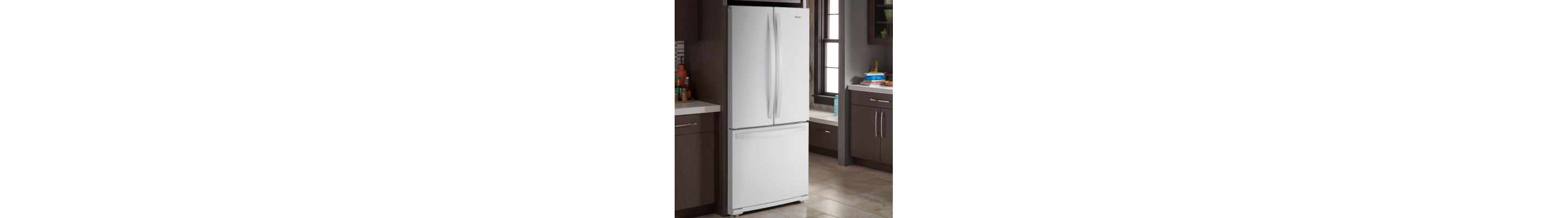 White Whirlpool® French door refrigerator in brown cabinetry
