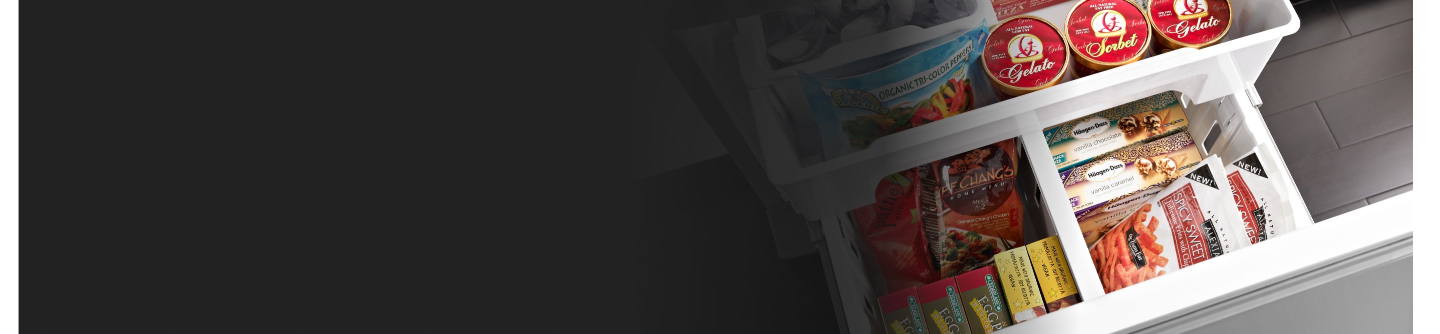 Birds-eye view of French door refrigerator pull-out freezer drawer full of food