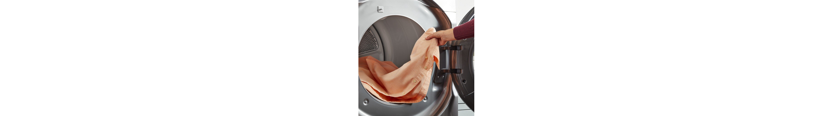 Hand pulling an item of clothing out of a dryer