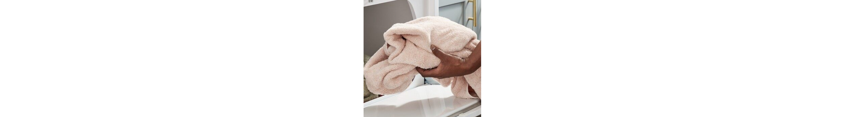 Hand pulling a towel out of dryer
