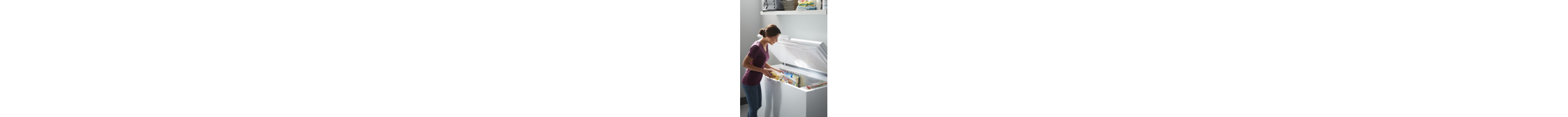 Person loading food into a standalone freezer
