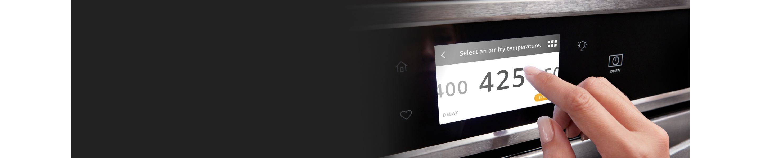 Finger touching digital display on oven