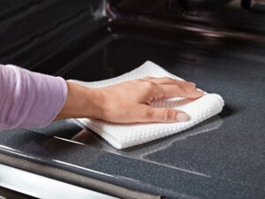 Person wiping out the inside of an oven