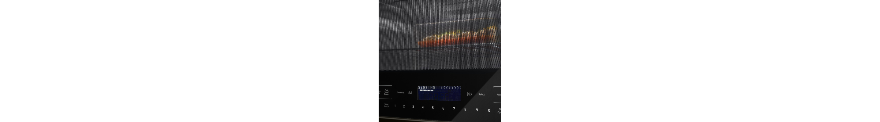 Closeup of a tray of food heating in a microwave