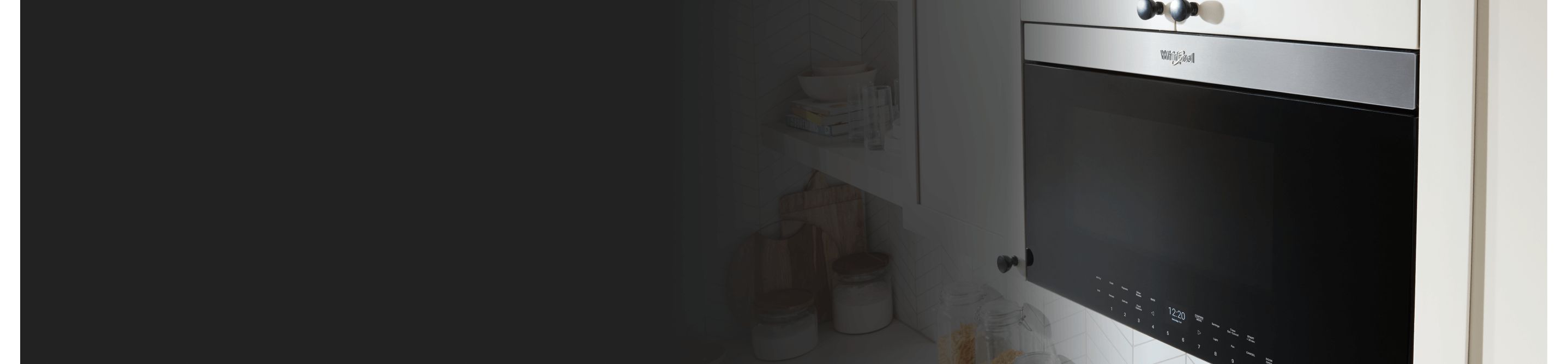 Black and silver Whirlpool® over-the-range microwave with a Flush Built-in Design