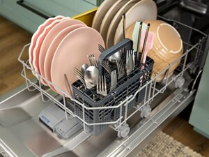 Open lower rack of a dishwasher filled with dishes