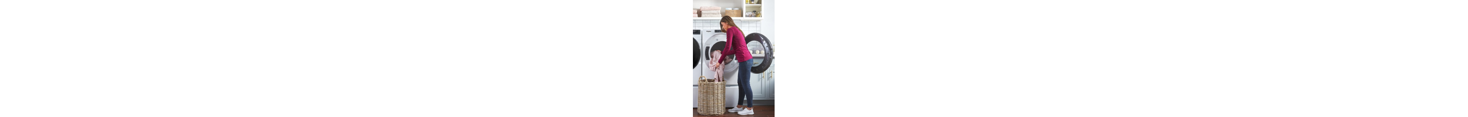 Person loading laundry into a dryer