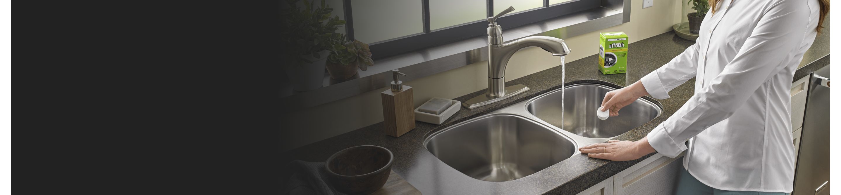 Person adding affresh® to a kitchen sink drain