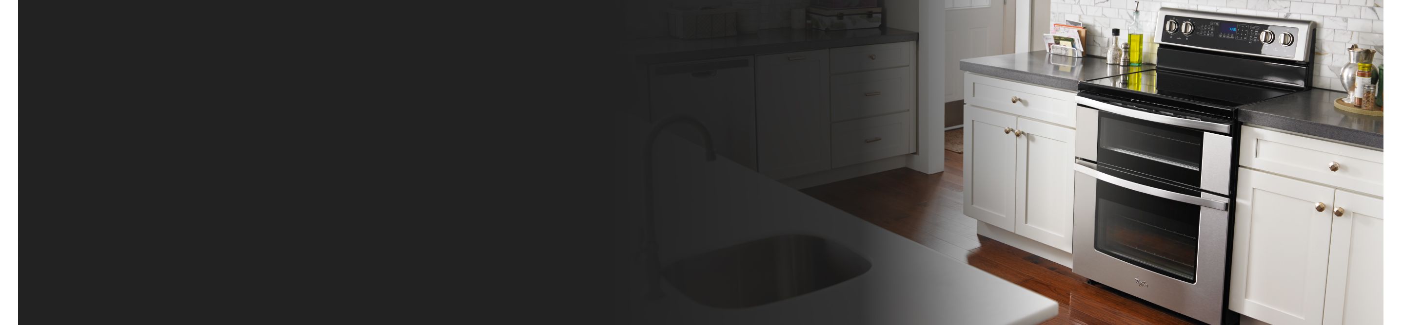 Kitchen with white cabinets and dark countertops
