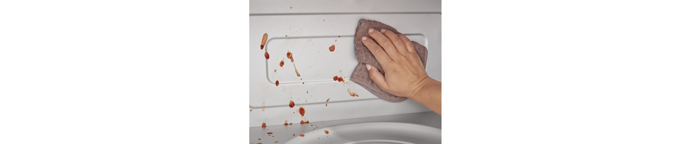Person wiping the inside of the microwave