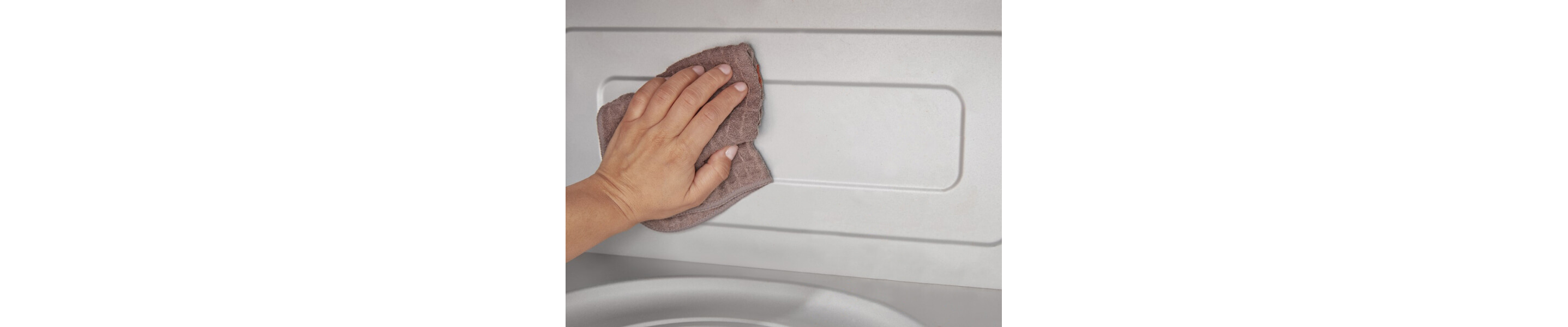 Person wiping the inside of a microwave with a cloth