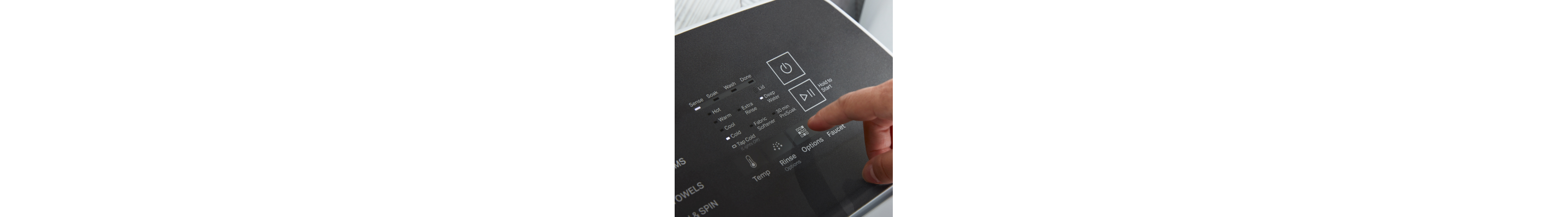 A finger hovering over cycle settings on a washer panel