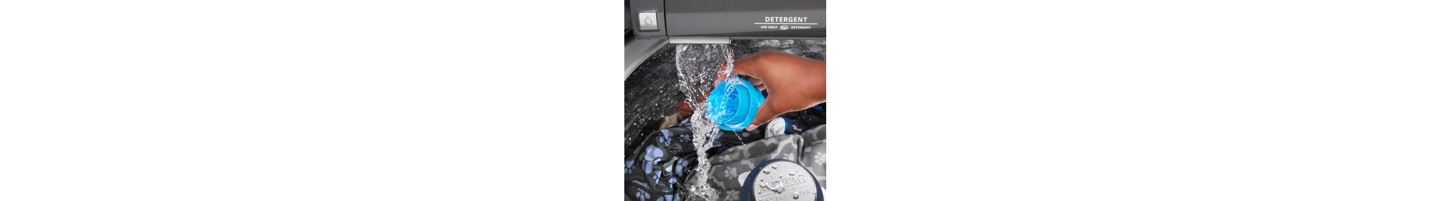 A person rinsing a detergent cap under the running water of a washer