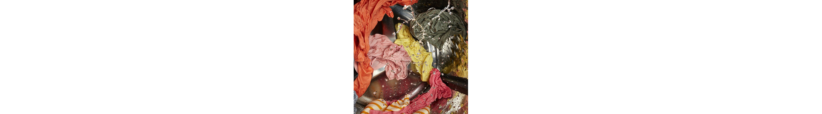 Wet clothes being washed in washer 