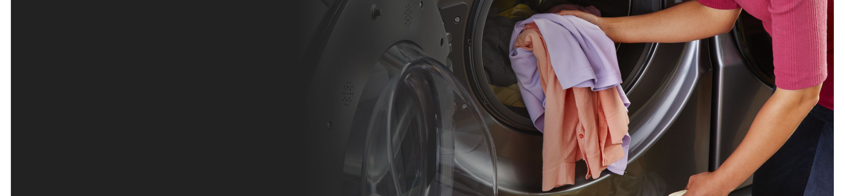 A person putting clothes into a Whirlpool® dryer