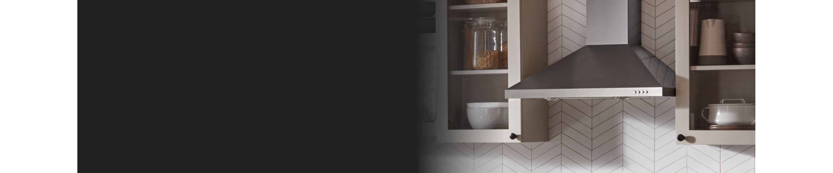 Range hood between white cabinets