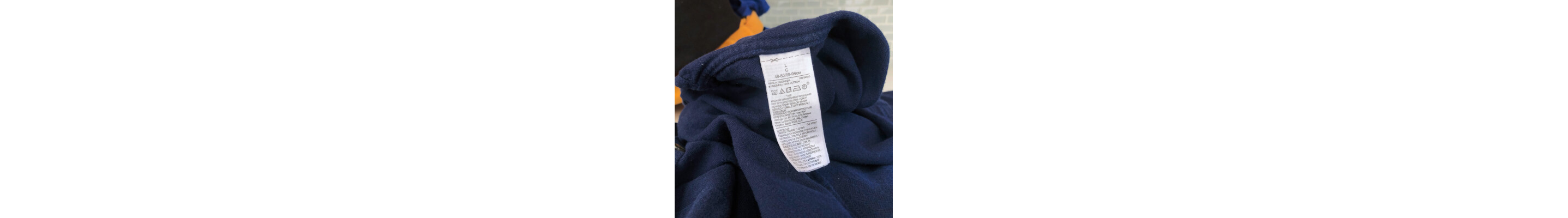Clothing care label on a blue shirt