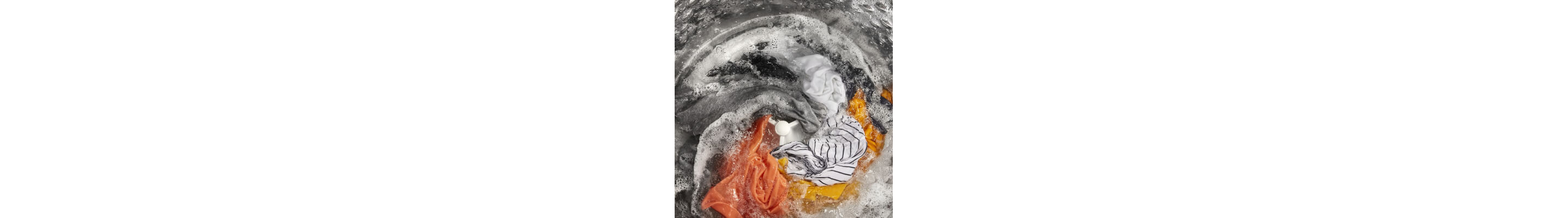 Clothes soaking in soapy water inside of a washer
