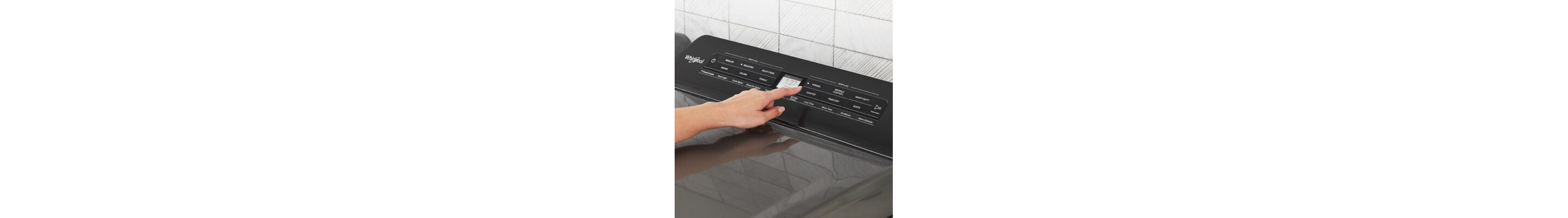 Person selecting cycle settings on a dryer