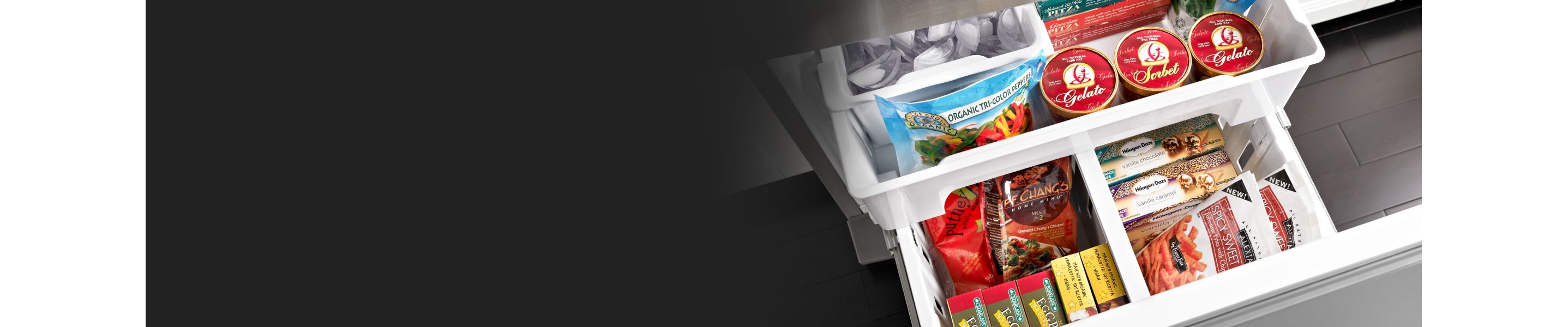 White freezer drawers opened showing a variety of frozen foods