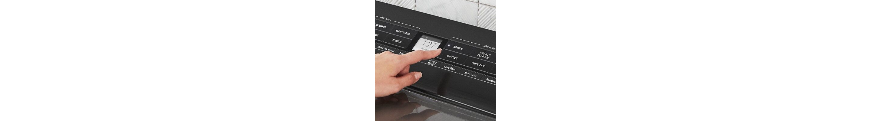 A person selecting dryer settings.