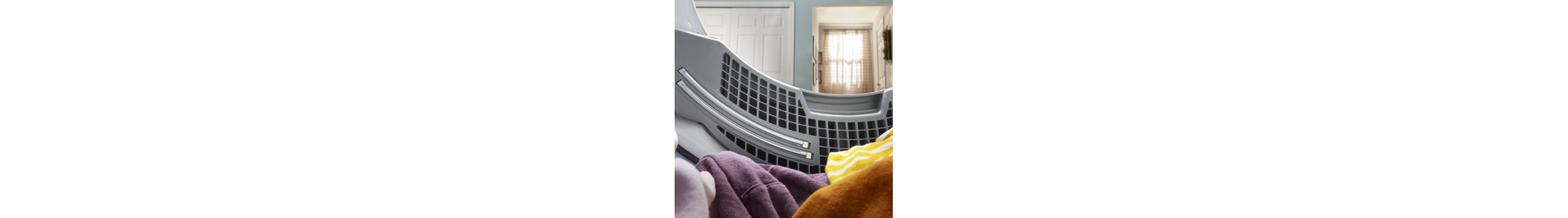 Laundry resting in the drum of an opened dryer.