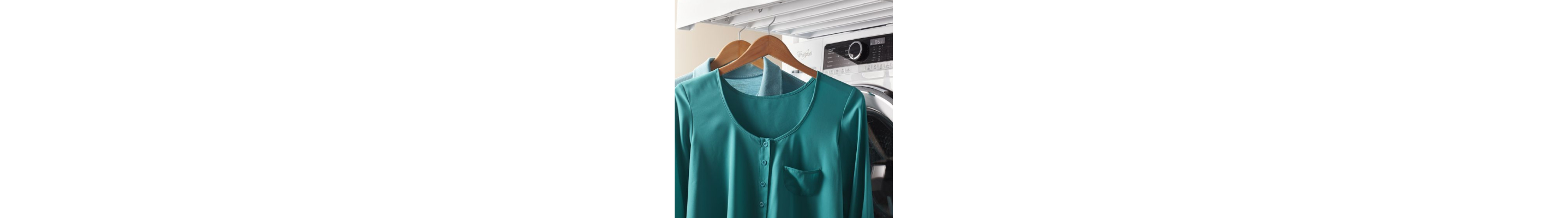 A teal blouse air drying on a hanger.