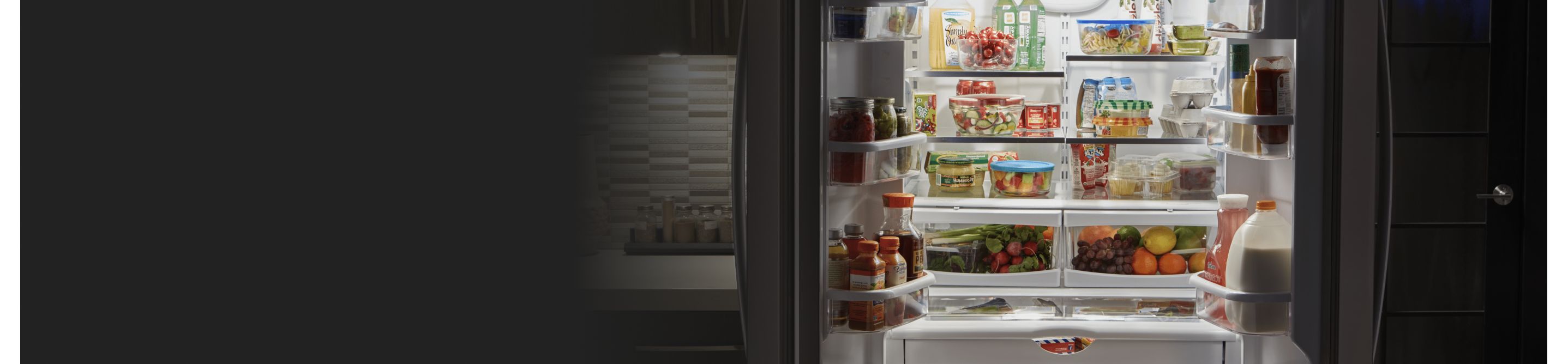 Open refrigerator full of fresh produce and groceries
