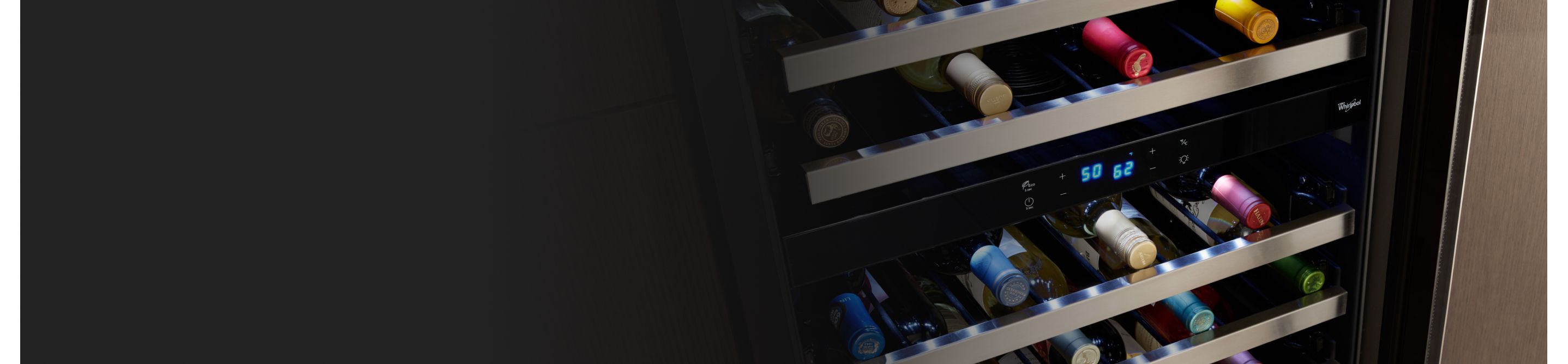 Wine bottles stored on the various levels of a wine fridge