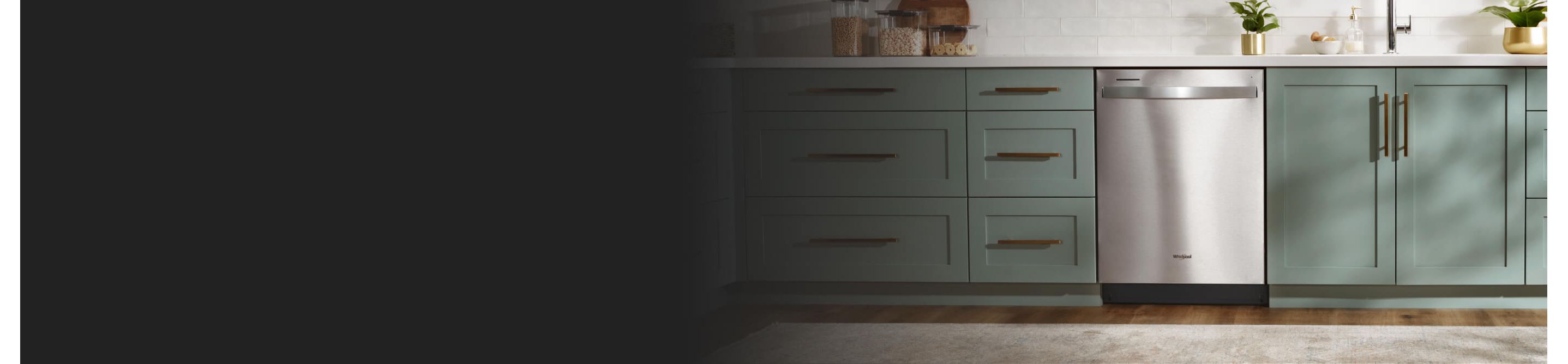 A Whirlpool® Dishwasher surrounded by teal cabinetry